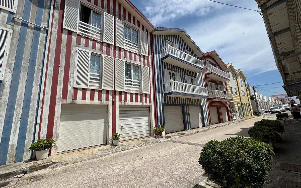 A street of red, blue and white striped houses with white shutters